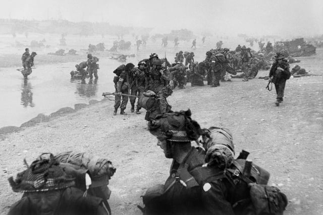 British troops take positions on Sword beach during D-Day 06 June 1944 after Allied forces stormed the Normandy beaches. D-Day, 06 June 1944 is still one of the world's most gut-wrenching and consequential battles, as the Allied landing in Normandy led to the liberation of France which marked the turning point in the Western theater of World War II. (Photo credit should read STR/AFP/Getty Images)