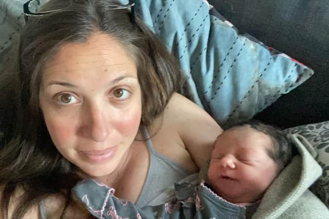 Rosa holding baby Saya in June 2021.