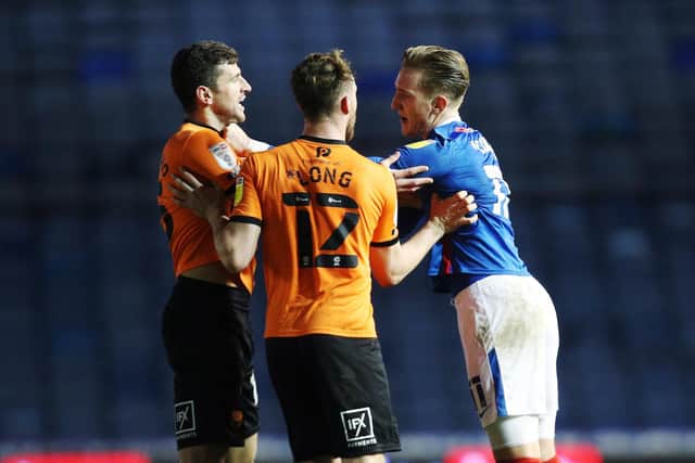 John Mousinho and Ronan Curtis go head-to-head during Pompey's 1-1 draw with Oxford at Fratton Park in 2020