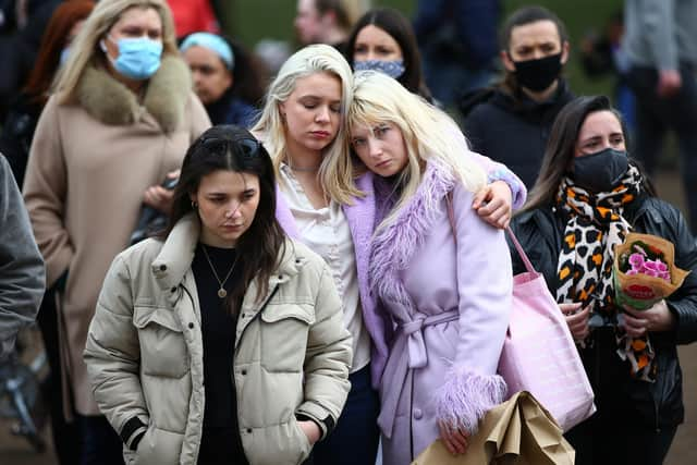 People pay their respects on Clapham Common, where floral tributes have been placed for Sarah Everard on March 14, 2021 in London.
Photo by Hollie Adams/Getty Images