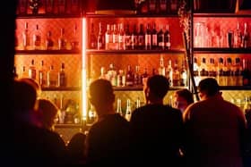People are a bar ordering drinks