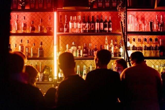 People are a bar ordering drinks