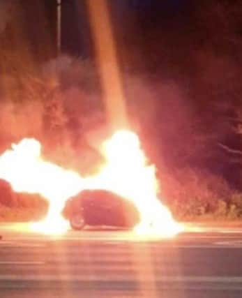 A man and dog escaped a car fire on the Eastern Road