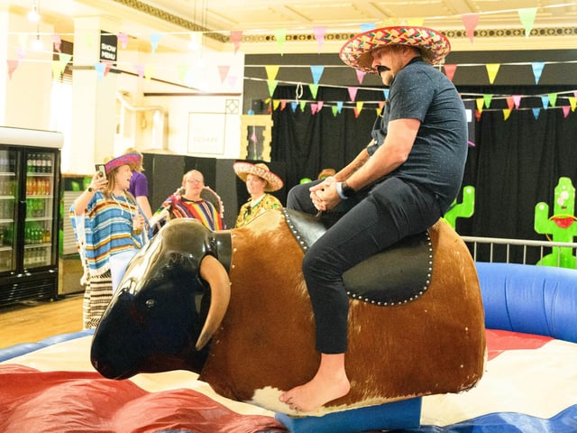 Pictured is: Riding the mechanical bull.
Picture: Keith Woodland