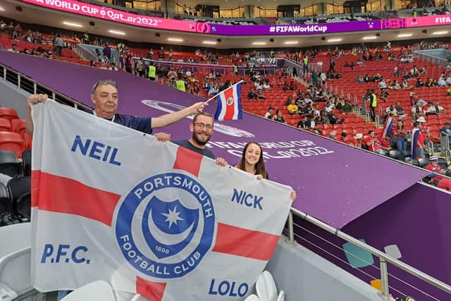 The unique Pompey FC flag bears the Portchester family members' names as they enjoy the trip of a lifetime - with high praises for host nation Qatar.