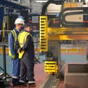 Workers watch a frigate steel cutting ceremony for the first of the class Type 31 frigate, at Babcock Rosyth, Fife. Picture: Andrew Milligan/PA Wire