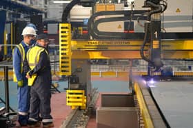 Workers watch a frigate steel cutting ceremony for the first of the class Type 31 frigate, at Babcock Rosyth, Fife. Picture: Andrew Milligan/PA Wire