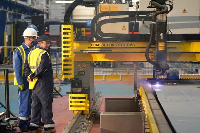 Workers watch a frigate steel cutting ceremony for the first of the class Type 31 frigate, at Babcock Rosyth, Fife. Picture: Andrew Milligan/PA Wire