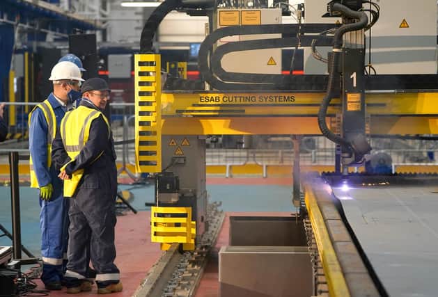 Workers watch a frigate steel cutting ceremony for the first of the class Type 31 frigate, at Babcock Rosyth, Fife. Picture: Andrew Milligan/PA Wire