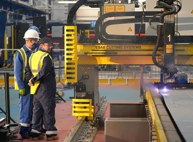 Workers watch a frigate steel cutting ceremony for the first of the class Type 31 frigate, at Babcock Rosyth, Fife. Picture: Andrew Milligan/PA Wire