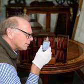 Charles Wallrock inspects one of the bottles in the medicine cabinet that belonged to Sir William Beatty, Nelson's surgeon at Trafalgar. 