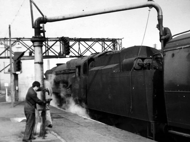 Here we see a young John Gardner assisting his driver filling up a loco tender with water at Basingstoke in 1967.