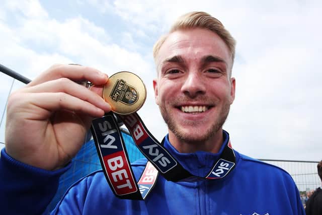Jack Whatmough won the League Two title with Pompey in 2016-17. He has now added League One honours to his trophy cabinet. Picture: Joe Pepler