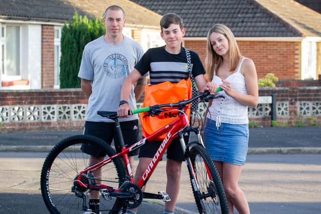Spencer Cartwright with his father Craig and mother Catherine outside their home in Waterlooville with the bike. Picture: Habibur Rahman