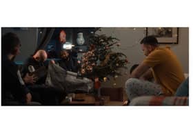 Worlds apart: a sailor celebrates Christmas Day in his ship while his family marks the occasion at home.