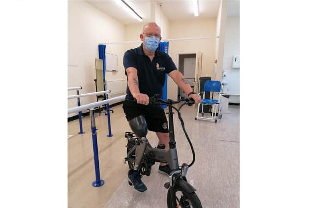 Amputee Derek Cassie with the bike. Picture: PHU