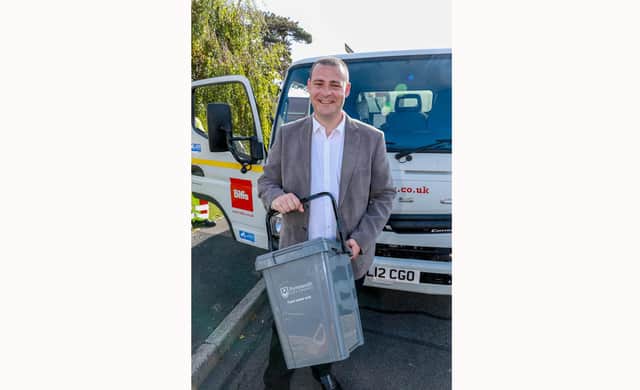 Cllr Dave Ashmore with one of the food waste caddies.