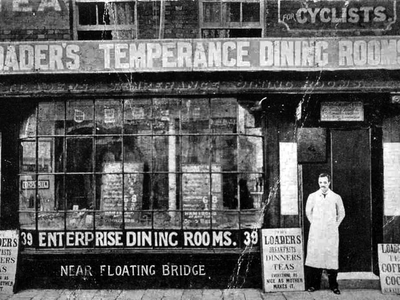 Located at the lower end of Broad Street we see Loader's Temperance Dining Rooms. The bill board outside states that the food is 'As nice as mother makes it'.