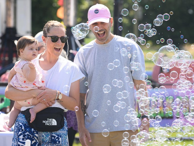A family enjoy enjoy the bubbles at the Party in the ParkPicture: Keith Woodland (270721-19)