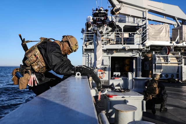 Royal Marines clamber off HMS Tamar to carrying out a boarding exercise. Photo: Royal Navy