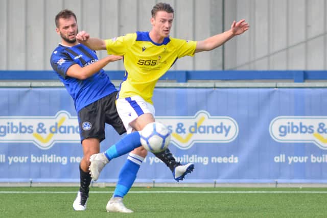Kristian Budini (Clanfield, blue) v Denmead. Picture: Martyn White