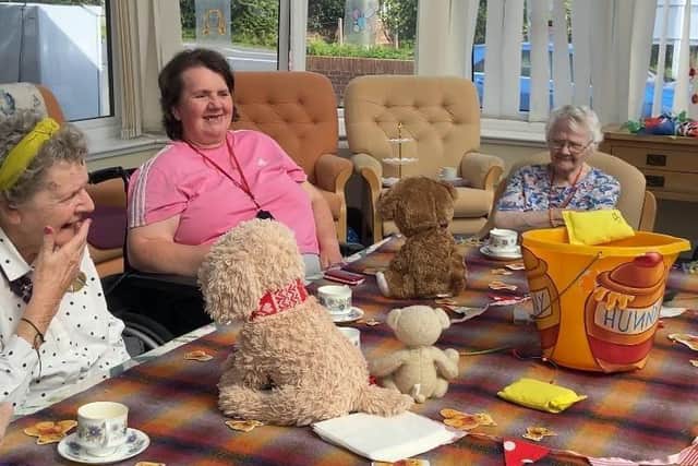 Residents enjoying cake, games, and teddy bears at Bedhampton Court.