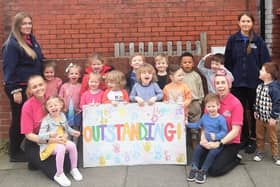 Children and staff celebrate the Outstanding rating.