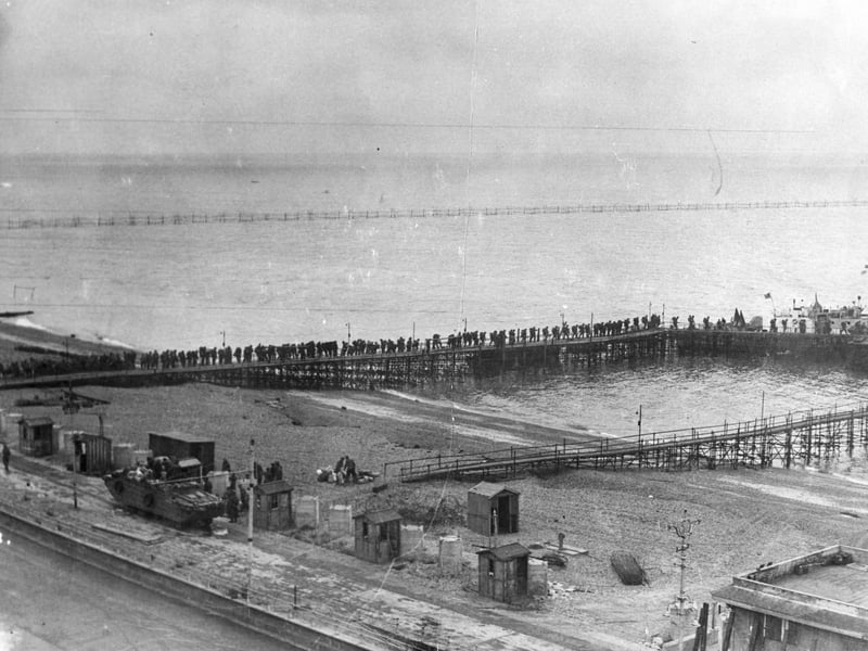 British troops on temporary piers alongside South Parade Pier. They are about to board an LCI(L) or Landing Craft, Infantry (Large) to take them to Normandy: it can be seen in the distance at the end of the pier.