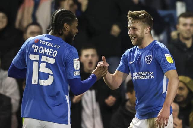 Michael Jacobs celebrates with Mahlon Romeo after netting Pompey's second goal against Burton. Picture: Robin Jones