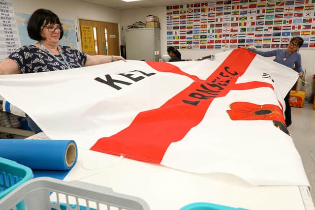 Julia Vassallo, left, and Surach Khomkhai with a finished flag. Hampshire Flag Company Ltd, Pipers Wood Industrial Park, Waterlooville
Picture: Chris Moorhouse (jpns 130721-02)

