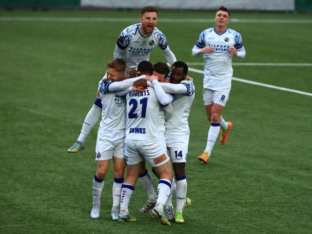 Sam Matthews is mobbed after scoring the late winner. Picture by Dave Haines