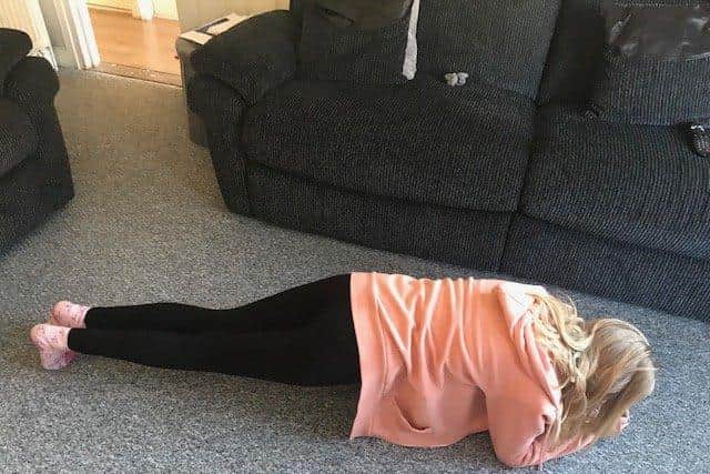 A child takinf part in the plank exercise at home.