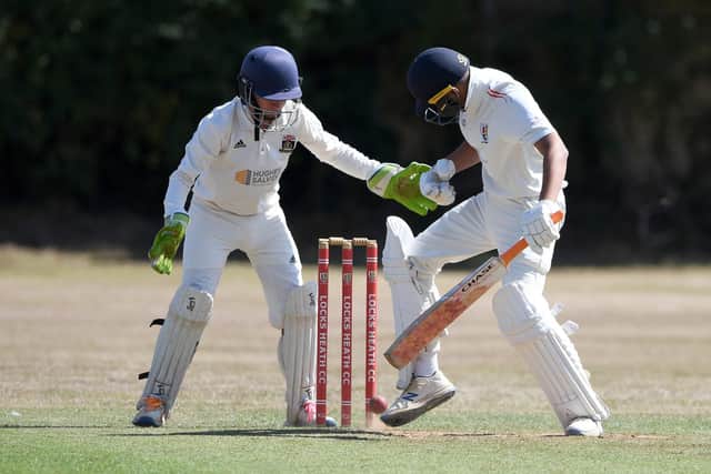 Locks Heath's Saransh Gupta kicks the ball away to prevent it hitting the stumps. Picture: Neil Marshall