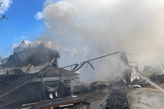 More than 80 firefighters were deployed to tackle a ferocious garage fire, which spread to nearby vehicles and buildings. Smoke could be seen filling the sky.