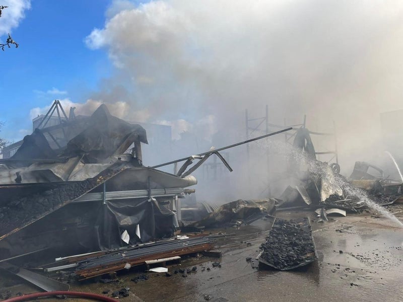More than 80 firefighters were deployed to tackle a ferocious garage fire, which spread to nearby vehicles and buildings. Smoke could be seen filling the sky.