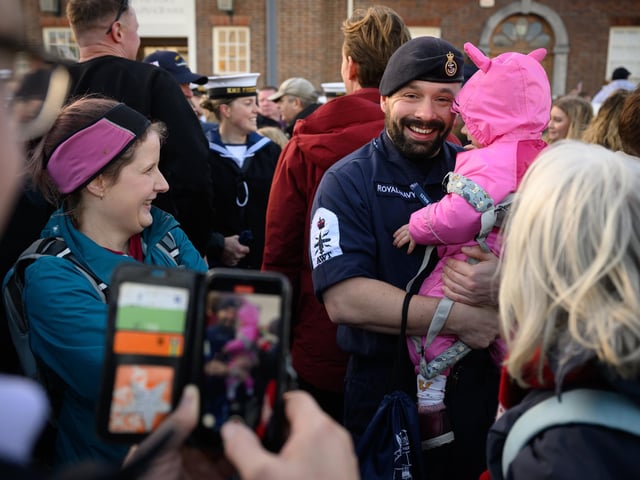 Petty Officer Nicholas Baker hugs his daughter Amelia-Rose following the return of the United Kingdom's biggest warship, the HMS Prince of Wales aircraft carrier, following a three months deployment, on December 11, 2023. Picture: Leon Neal/Getty Images
