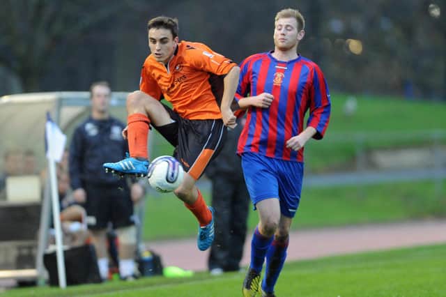 Flashback to the last time Us Portsmouth took on AFC Portchester in the FA Vase - Rob Evans (orange) takes on Callum Coker. Picture: Ian Hargreaves