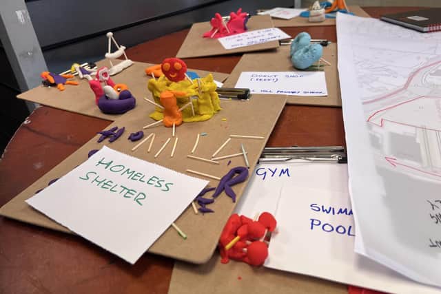 Children make Play Doh figures of their ideas and build a homeless shelter