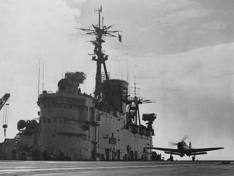 A Fairey Firefly carrier-borne fighter and anti-submarine aircraft  landing on the flight deck of the Royal Navy Audacious-class fleet aircraft carrier HMS Eagle during exercises in the English Channel on 19 March 1952.