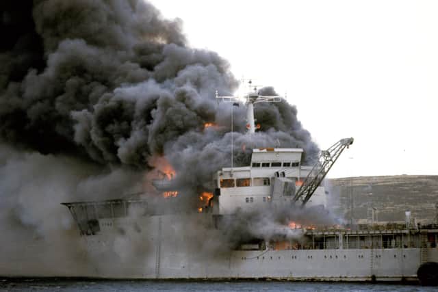 RFA Sir Galahad ablaze after the Argentine air raid at Bluff Cove near Fitzroy settlement on East Falkland Picture: Martin Cleaver/PA Wire