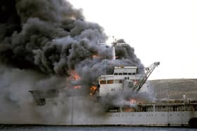 RFA Sir Galahad ablaze after the Argentine air raid at Bluff Cove near Fitzroy settlement on East Falkland Picture: Martin Cleaver/PA Wire