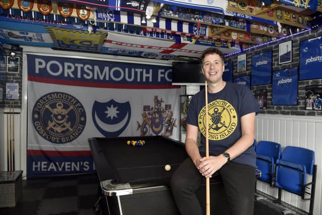 Aaron Haggard (39) from Gosport, has turned one of his rooms at his house into a man cave complete with Pompey memorabilia and a pool table. Picture: Sarah Standing (201023-9965).