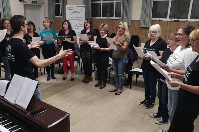 Encore Choirs, based in Petersfield and Farnham, are run by Portsmouth resident Josh Robinson and his fiancee Gemma Ford. Members of the group recorded a virtual performance of Josh's song Let Light, Let Love to support Age UK. Pictured: A choir group performing together before they had to meet online