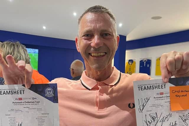 Pompey fan Julian Browning with signed teamsheets after his surprise linesman outing against Cheltenham