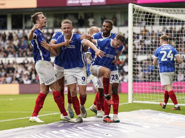 Pompey goalscorer Colby Bishop is mobbed by his Blues team-mates as the fans go wild in the stands
