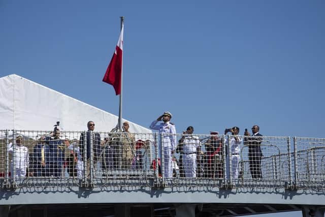Bahrani military officials salute their nation's flag, which was raised on the flight deck of the former HMS Clyde. Photo: Twitter/Bahrain Embassy UK