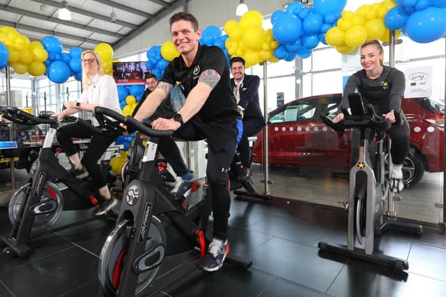 Richmond Motorgroup, in Farlington, held a sponsored static bike ride with all donations going to Ukraine via the Disasters Emergency Committee appeal. Personal trainer Luke Wilson is nearest the cameraPicture: Chris Moorhouse (jpns 090322-03)