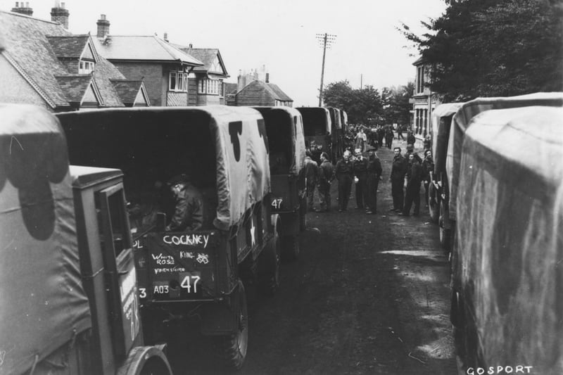 British Army lorries queue to embark onto landing craft bound for Normandy at Hardway, Gosport. Troops often spent time waiting to load, and sometimes had to spend the night in the street. They often go chatting to local people who made small acts of kindness for them e.g. cooked a meal (despite food rationing) or let them sleep in their house rather than in their vehicles.