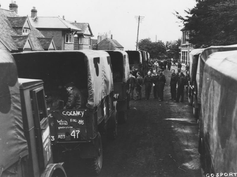 British Army lorries queue to embark onto landing craft bound for Normandy at Hardway, Gosport. Troops often spent time waiting to load, and sometimes had to spend the night in the street. They often go chatting to local people who made small acts of kindness for them e.g. cooked a meal (despite food rationing) or let them sleep in their house rather than in their vehicles.