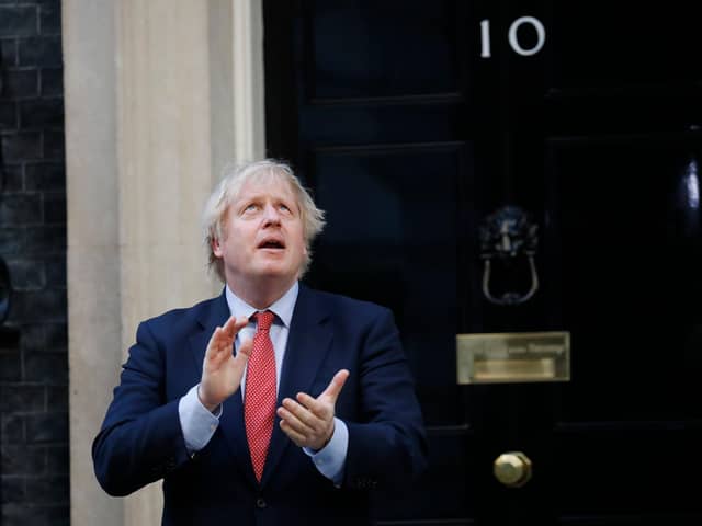 Britain's Prime Minister Boris Johnson participates in a national clap for carers to show thanks for the work of Britain's NHS (National Health Service) workers and other frontline medical staff around the country as they battle with the novel coronavirus pandemic, outside 10 Downing Street (Photo by Tolga AKMEN / AFP) (Photo by TOLGA AKMEN/AFP via Getty Images)